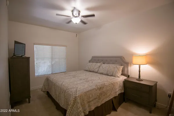 a bedroom with a bed and a lamp
