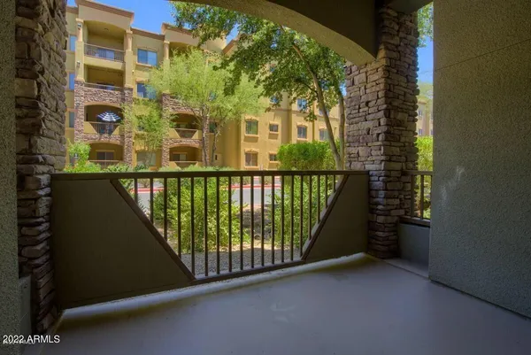 a view of a balcony with a tree