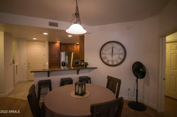 a view of a dining room with furniture and a chandelier