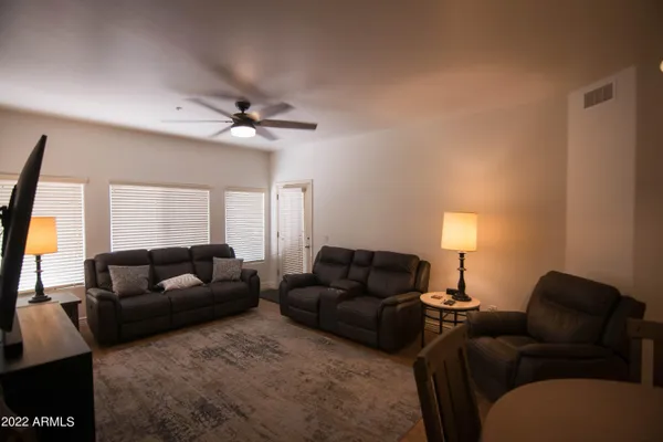 a living room with furniture a window and a flat screen tv