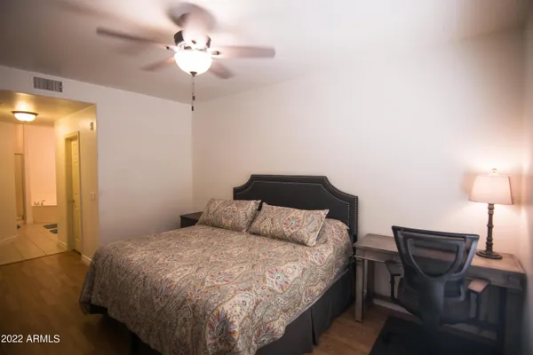 a bedroom with a bed and a chandelier