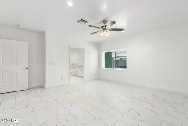 a spacious bathroom with a shower sink and mirror