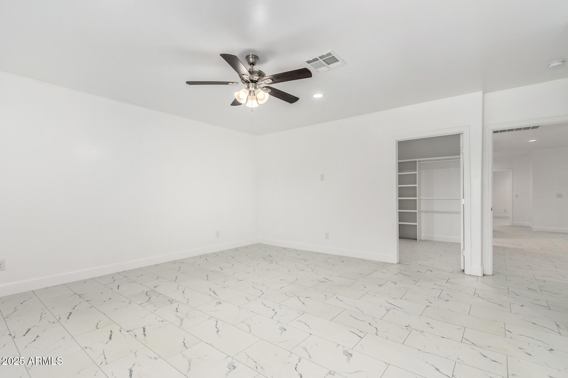 15640 North Verde Street Surprise, AZ 85378 - Photo 16 of 56 an empty room with a ceiling fan and carpet