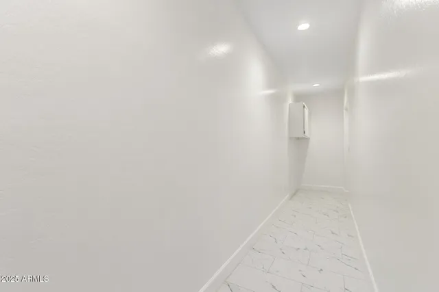 a bathroom with a granite countertop toilet sink and mirror