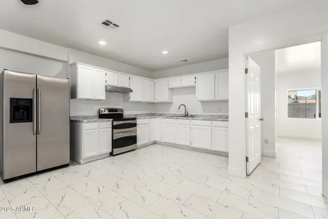 an empty room with a ceiling fan and window
