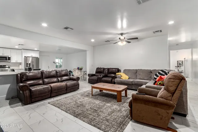 a kitchen with a dining table chairs and white cabinets
