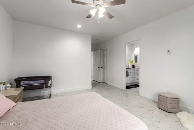 a bedroom with a bed and a table in it