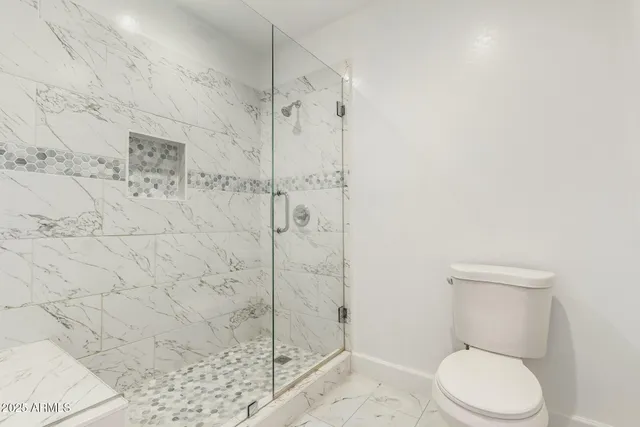 a bathroom with a sink vanity mirror and toilet
