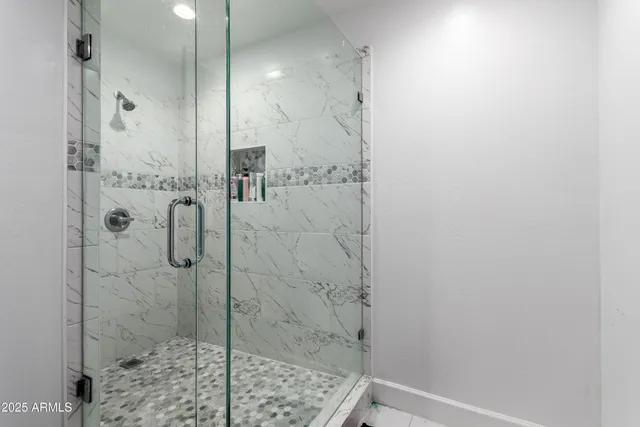 a view of a kitchen with fridge and workspace