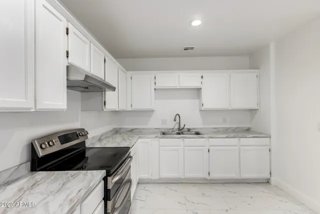 a view of a kitchen with furniture and a ceiling fan