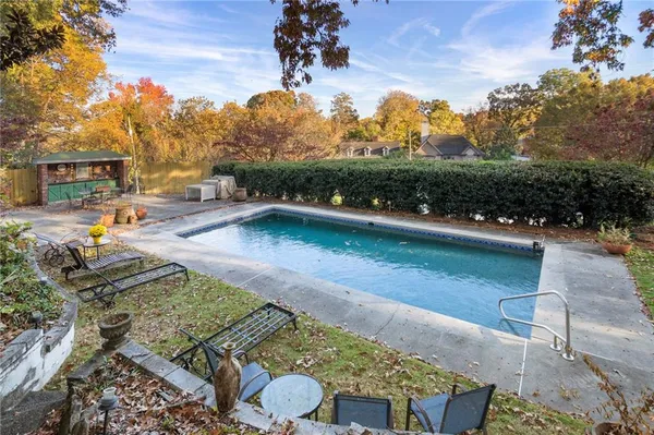 a living room with furniture wooden floor and a large window
