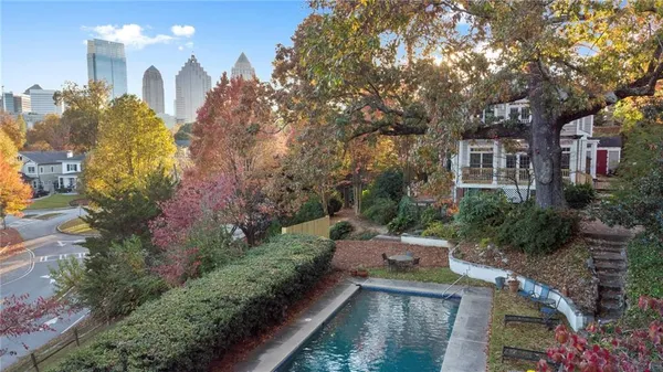 a living room with furniture a chandelier and a fireplace