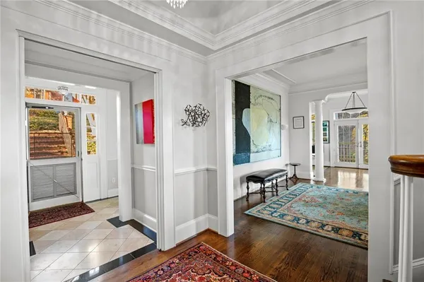 a view of a dining room with furniture wooden floor and chandelier