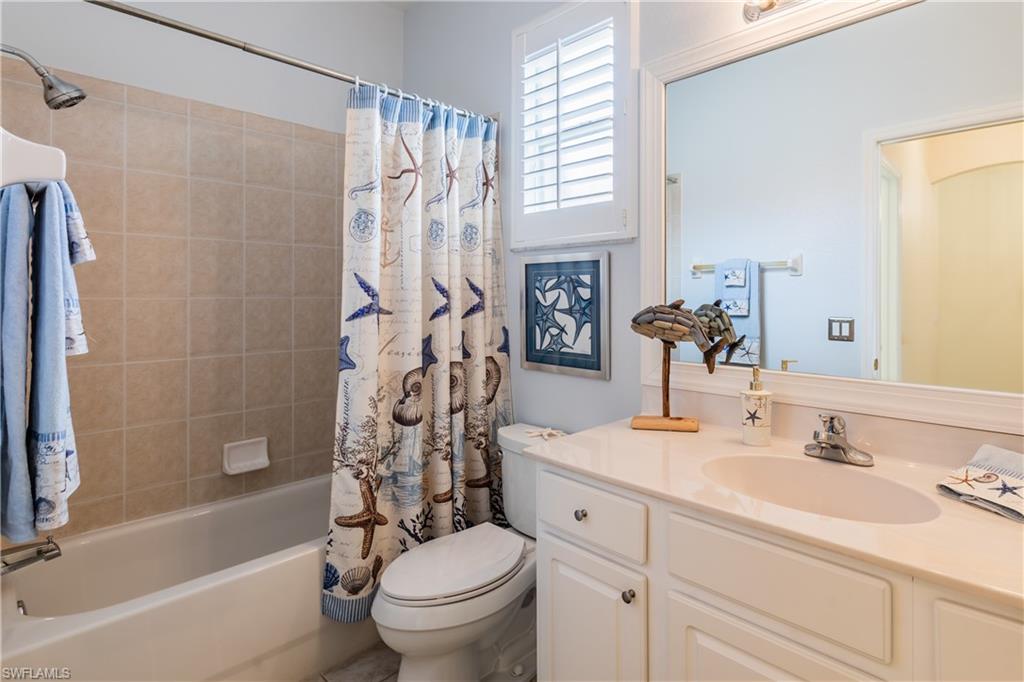 14151 Fall Creek Court Naples, FL 34114 - Photo 16 of 35 a bathroom with a sink toilet and shower