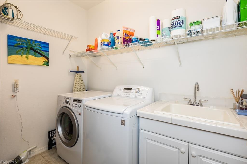 14151 Fall Creek Court Naples, FL 34114 - Photo 18 of 35 a utility room with dryer and washer