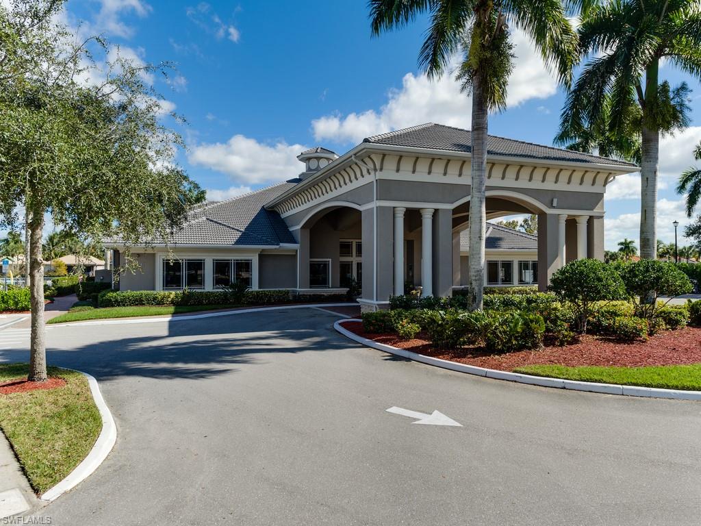14151 Fall Creek Court Naples, FL 34114 - Photo 23 of 35 a front view of a house with a garden