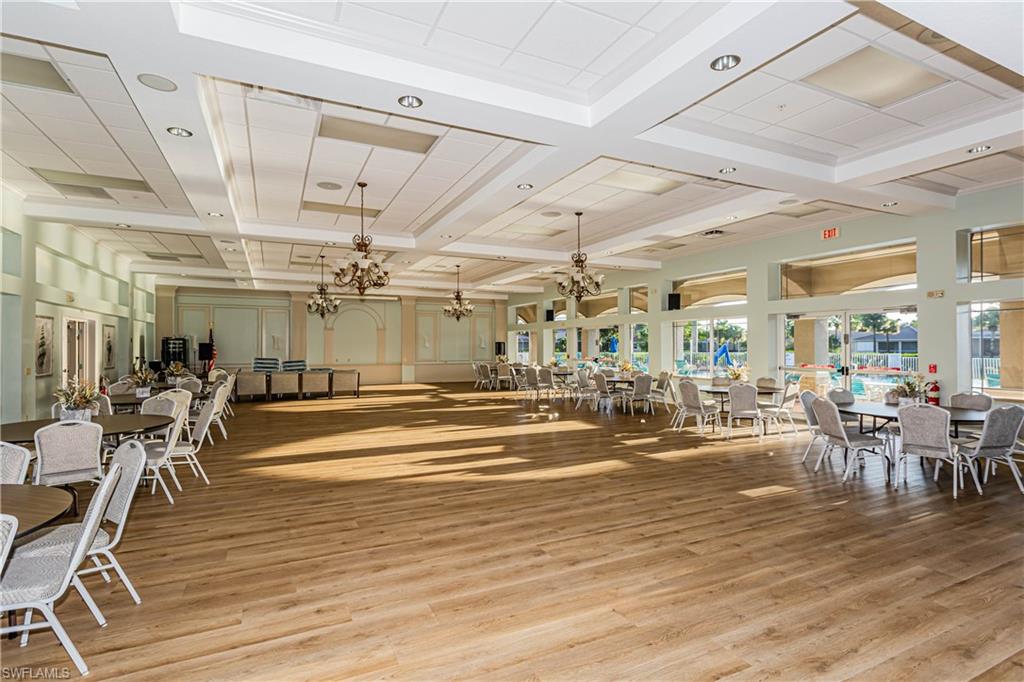 14151 Fall Creek Court Naples, FL 34114 - Photo 26 of 35 a room with lots of tables a chandelier and view of living room