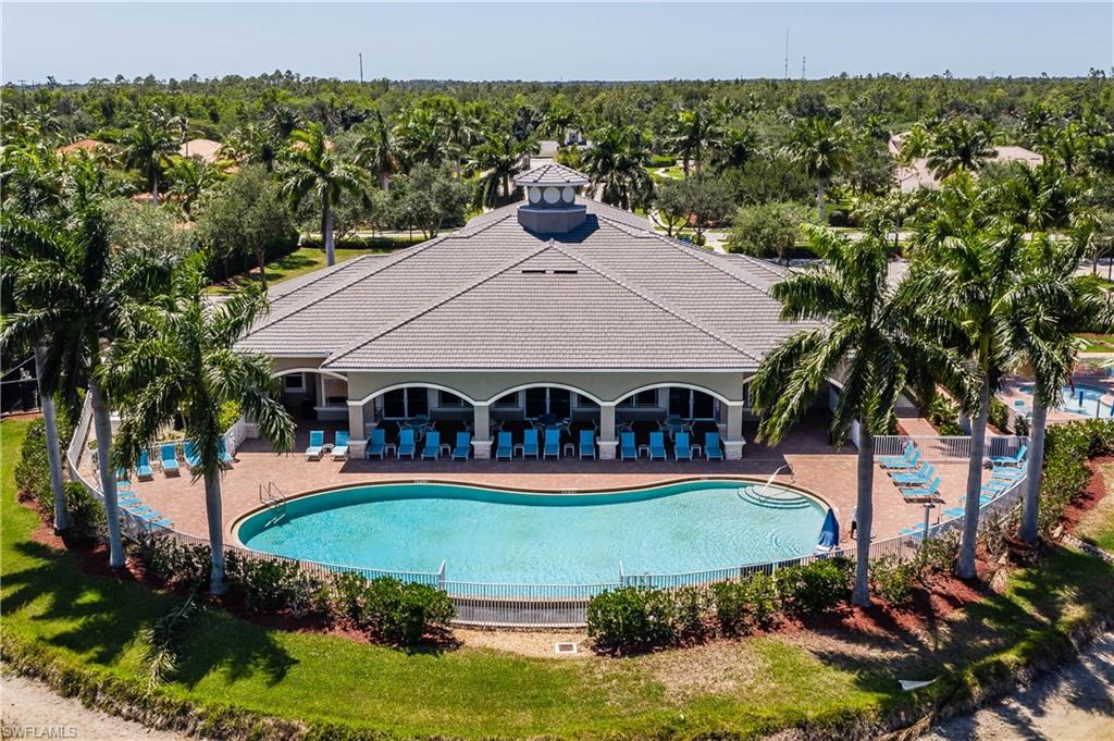 14151 Fall Creek Court Naples, FL 34114 - Photo 31 of 35 a view of a house with big yard and large trees