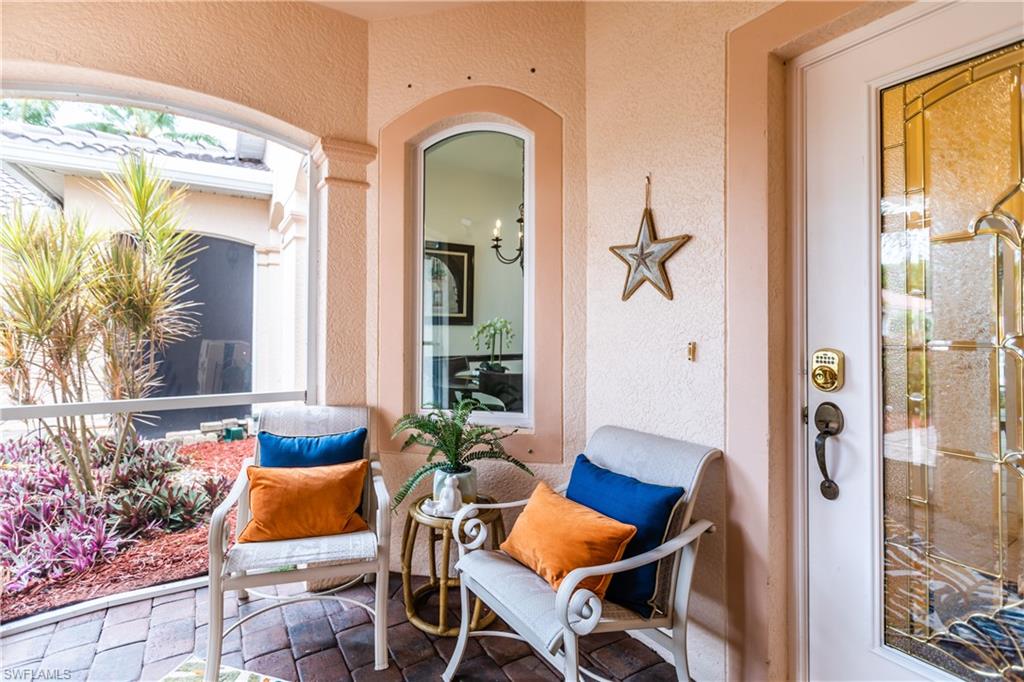 14151 Fall Creek Court Naples, FL 34114 - Photo 4 of 35 a view of a livingroom with furniture and a potted plant