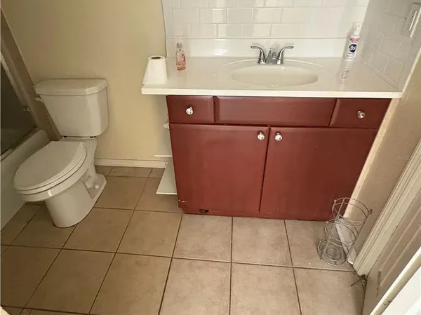 a bathroom with a toilet a sink and mirror