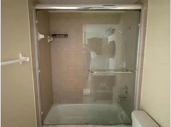 a bathroom with a glass shower door