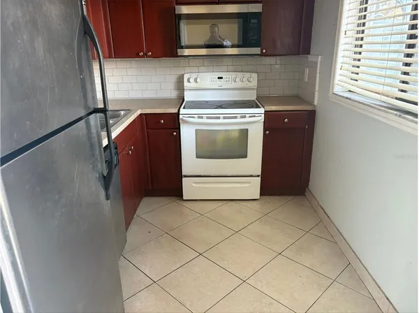 a kitchen with a stove and a microwave
