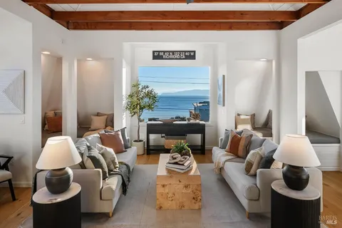 a view of a chairs and table in a balcony