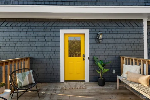 a living room with furniture and a lamp
