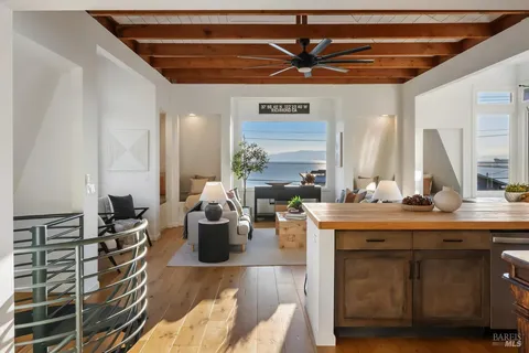 a kitchen with stainless steel appliances a sink a table and chairs