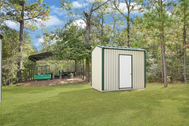 a view of a house with backyard and sitting area