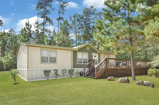a view of a house with a backyard