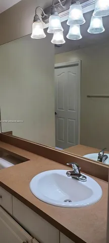 a kitchen with a sink a microwave and cabinets