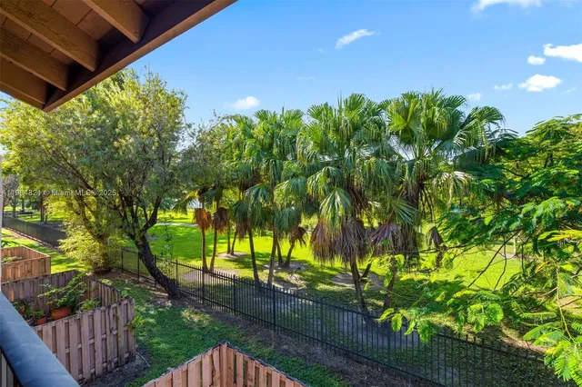 a view of a swimming pool with chair and tables