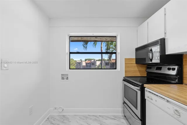 a kitchen with stainless steel appliances a refrigerator and a stove top oven