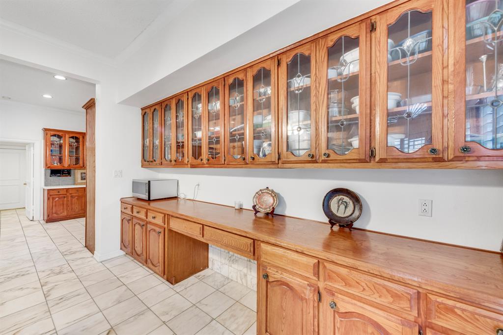 7204 Debbe Drive Dallas, TX 75252 - Photo 18 of 40 a kitchen with stainless steel appliances a sink and cabinets