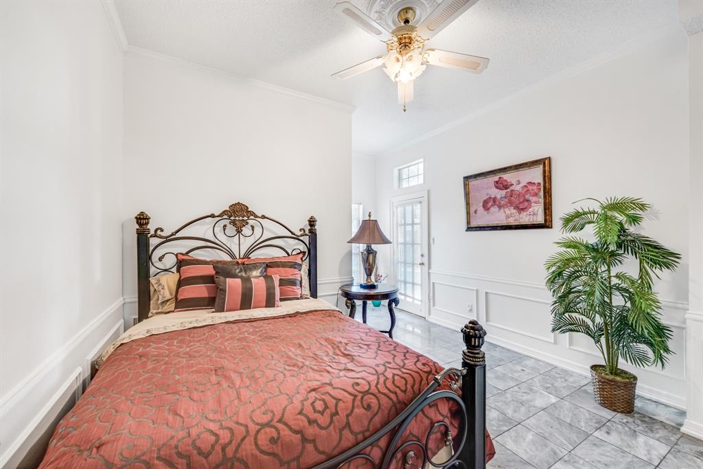 7204 Debbe Drive Dallas, TX 75252 - Photo 20 of 40 a bedroom with a bed and a chandelier