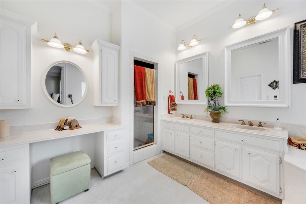 7204 Debbe Drive Dallas, TX 75252 - Photo 27 of 40 a bathroom with a sink vanity and mirror