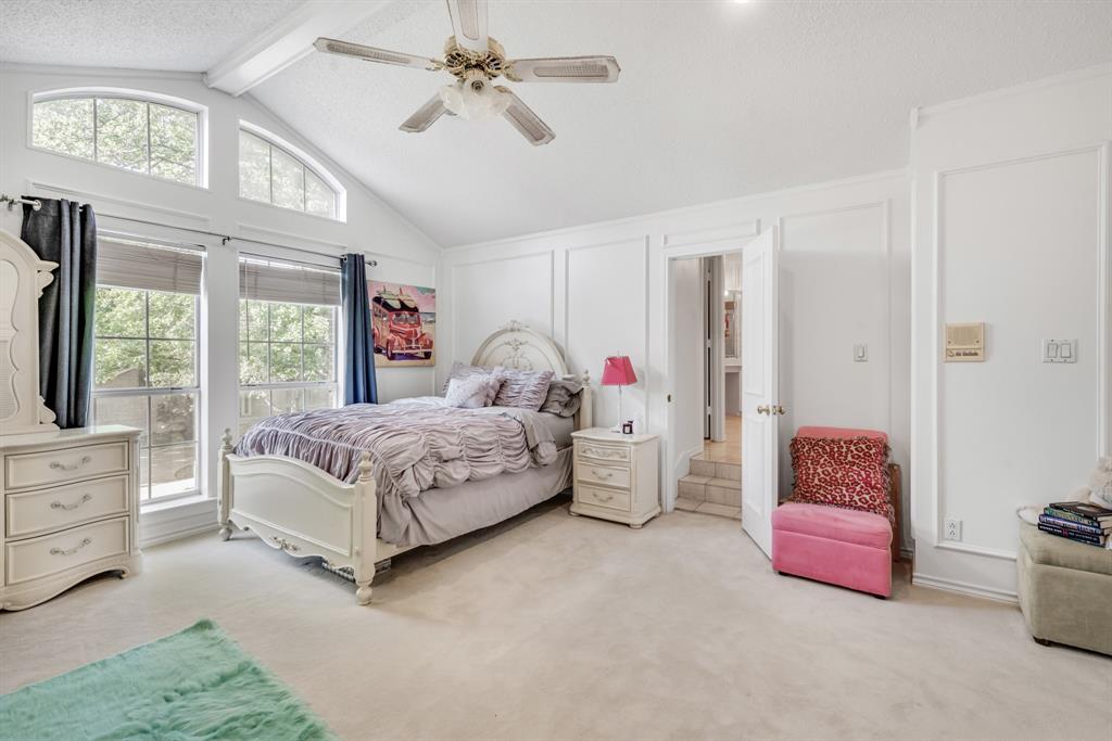 7204 Debbe Drive Dallas, TX 75252 - Photo 32 of 40 a bedroom with a bed and a chandelier