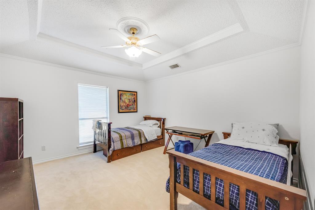 7204 Debbe Drive Dallas, TX 75252 - Photo 35 of 40 a bedroom with furniture and a chandelier