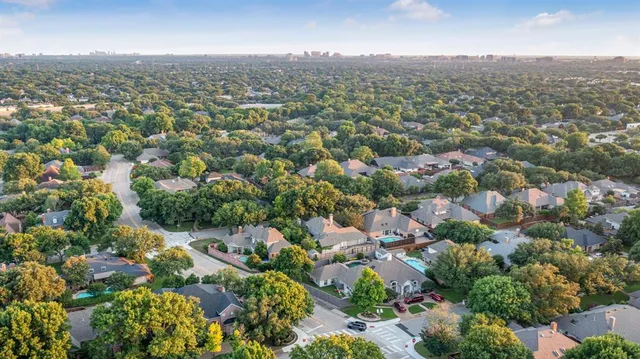 an aerial view of a house with garden space and trees