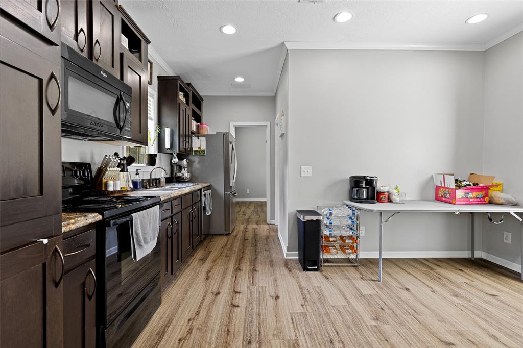 3489 Lotta Road Karnack, TX 75661 - Photo 13 of 39 a kitchen with a sink and wooden floor