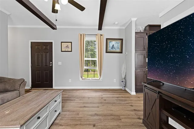 a bedroom with a bed and a dresser next to a window