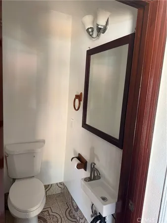 a bathroom with a toilet sink and mirror