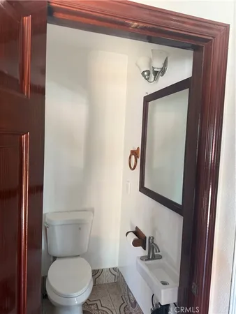 a white toilet sitting next to a bathroom sink