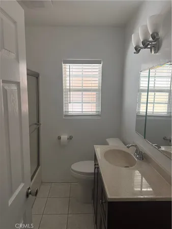 a bathroom with a sink toilet and window