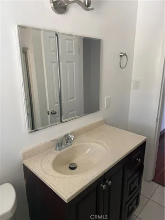 a bathroom with a sink vanity and a toilet