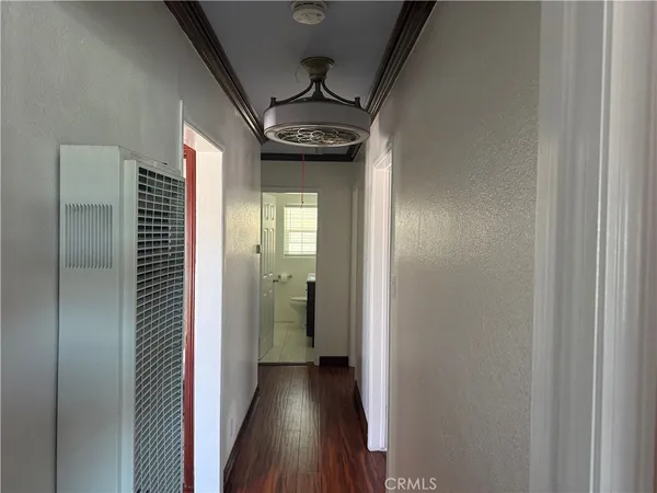 a view of hallway with wooden floor
