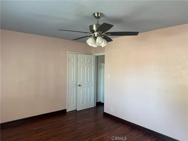 a view of a chandelier fan and hardwood floor