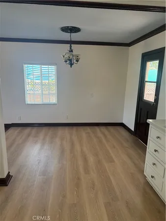 a view of room with hardwood floor and cabinet