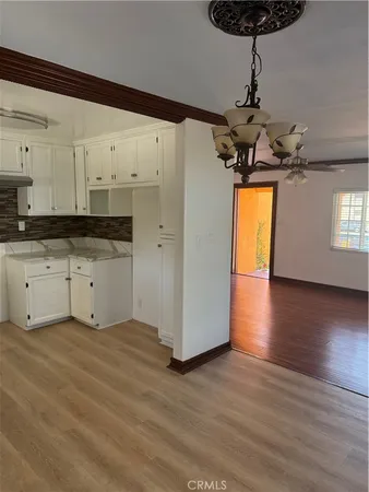 a kitchen with stainless steel appliances a stove a refrigerator and a hard wood floor